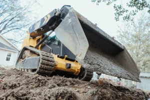 A skid steer being used to clear land